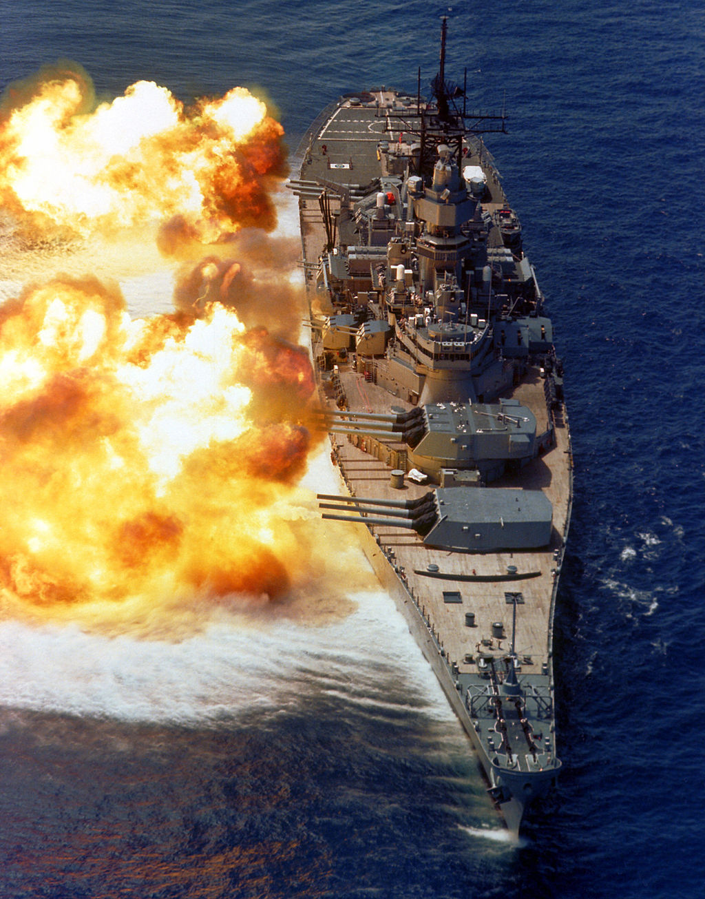 An image of an American warship firing a massive broadside.